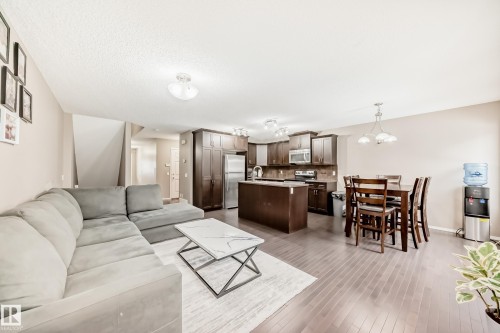 Open concept living area featuring hardwood flooring, recessed lighting, and a neutral wall color - 8 13838 166Ave, Edmonton, AB - Indoor