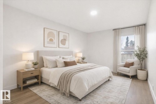 The bedroom features light-colored walls and flooring, with a window offering views of greenery and a fence - 6540 184 Street, Edmonton, AB - Indoor Photo Showing Bedroom