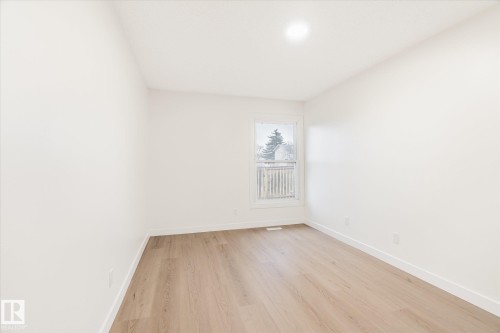 Room with light wood flooring, white walls, and a window providing natural light - 6540 184 Street, Edmonton, AB - Indoor Photo Showing Other Room