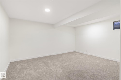 This room features plush grey carpeting, white walls, and a recessed ceiling light - 6540 184 Street, Edmonton, AB - Indoor Photo Showing Other Room