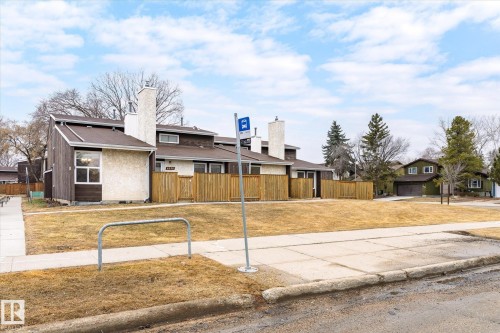 The property features a brown exterior with a white chimney and a brown roof - 6540 184 Street, Edmonton, AB - Outdoor
