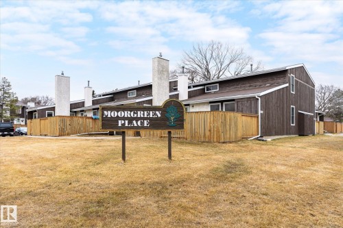 The property features a brown exterior with white trim, multiple white chimneys, and private fenced yard spaces - 6540 184 Street, Edmonton, AB - Outdoor