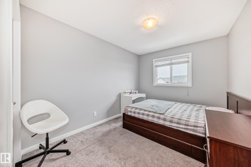 This room features light grey walls, a window with horizontal blinds, and grey carpet flooring - 5868 Anthony Crescent, Edmonton, AB - Indoor Photo Showing Bedroom