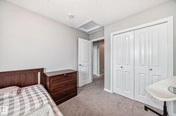 Well-appointed room featuring a white interior door, white bi-fold closet doors, and light-toned carpeting - 