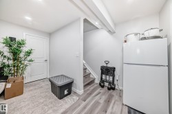 This property features recessed lighting, a white door, and light wood flooring - 