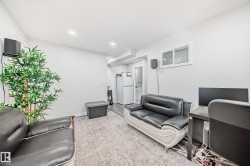 Living area with light-colored walls and recessed lighting - 