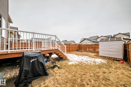 The property features a wooden deck with white railings, providing outdoor living space - 5868 Anthony Crescent, Edmonton, AB - Outdoor With Deck Patio Veranda With Exterior