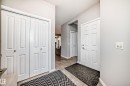 Entryway featuring tile flooring, white paneled doors, and light gray walls - 5868 Anthony Crescent, Edmonton, AB  - Indoor 