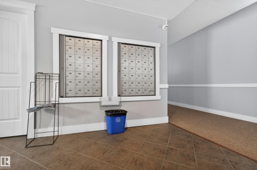 The property features a common area with individual mailboxes and a tiled floor - 131 2098 Blackmud Creek Drive Sw, Edmonton, AB - Indoor Photo Showing Other Room