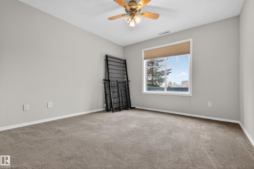 Room featuring light grey walls, a ceiling fan, and carpeted flooring - 131 2098 Blackmud Creek Drive Sw, Edmonton, AB - Indoor Photo Showing Other Room
