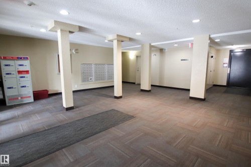 Lobby area featuring patterned carpet flooring, recessed lighting, and wall-mounted mailboxes - 405 534 Watt Boulevard, Edmonton, AB - Indoor Photo Showing Other Room