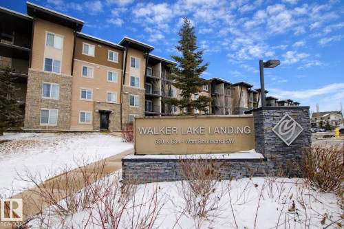 The property features a multi-story building with stone and siding exterior, offering a blend of textures - 405 534 Watt Boulevard, Edmonton, AB - Outdoor With Facade