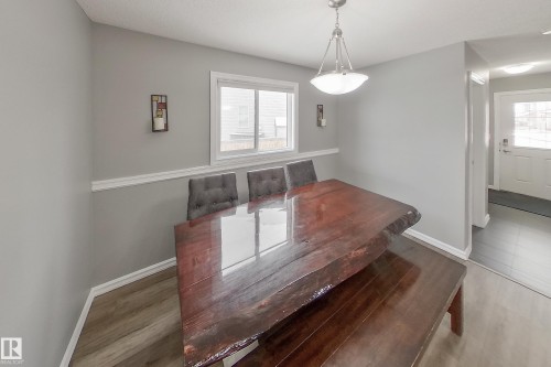 Dining area featuring neutral wall tones, a window providing natural light, and a ceiling-mounted light fixture - 635 41 Avenue, Edmonton, AB - Indoor Photo Showing Other Room