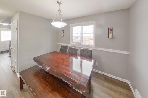 Dining area featuring a window, light gray walls, and wood-style flooring - 635 41 Avenue, Edmonton, AB - Indoor Photo Showing Other Room