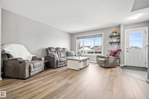 The property features light-colored walls and wood-style flooring throughout - 635 41 Avenue, Edmonton, AB - Indoor Photo Showing Living Room