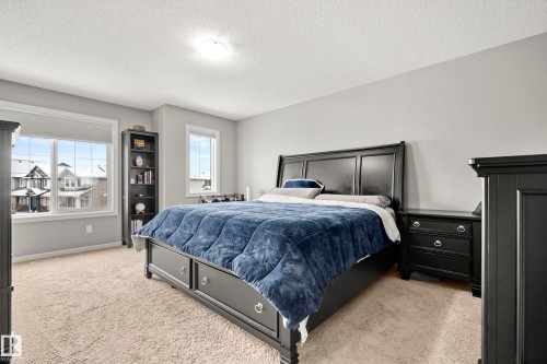This room features light-colored walls and carpeted flooring - 635 41 Avenue, Edmonton, AB - Indoor Photo Showing Bedroom