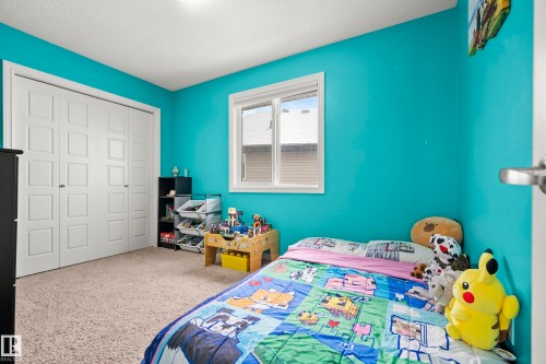 This room features bright turquoise walls, a window with blinds, and light-colored carpeting - 635 41 Avenue, Edmonton, AB - Indoor Photo Showing Bedroom