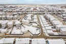 Aerial view of the property and surrounding neighborhood, featuring a detached garage, a fenced yard, and residential streets - 635 41 Avenue, Edmonton, AB  - Outdoor With View 
