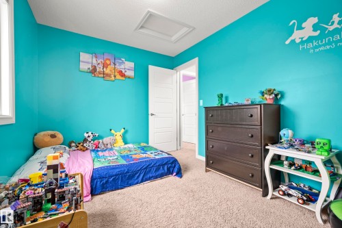 This room features vibrant turquoise walls and a window providing natural light - 635 41 Avenue, Edmonton, AB - Indoor Photo Showing Bedroom