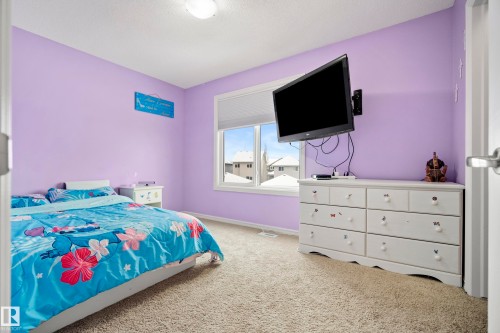 This room features soft purple walls and a window with blinds, allowing for control over natural light - 635 41 Avenue, Edmonton, AB - Indoor Photo Showing Bedroom
