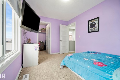 This room features light purple walls, carpeted flooring, and a window providing natural light - 635 41 Avenue, Edmonton, AB - Indoor Photo Showing Bedroom