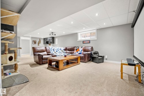 Expansive room featuring light-colored carpeting, recessed lighting, and a window - 635 41 Avenue, Edmonton, AB - Indoor Photo Showing Other Room