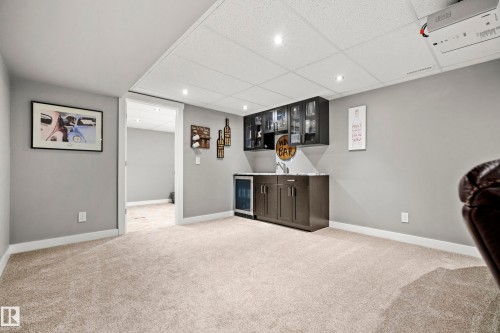 The property features a finished room with light-colored carpeted flooring and light grey walls - 635 41 Avenue, Edmonton, AB - Indoor