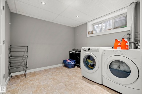 The property features a laundry area with tiled flooring, a window providing natural light, and a drop ceiling with recessed lighting - 635 41 Avenue, Edmonton, AB - Indoor Photo Showing Laundry Room