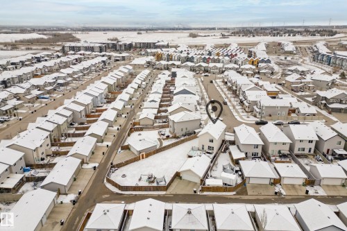 Aerial view of the property and its surrounding neighborhood, featuring a detached residence with a backyard, a driveway, and a garage - 635 41 Avenue, Edmonton, AB - Outdoor With View