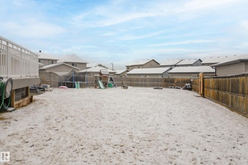 The property features a spacious backyard with a wooden privacy fence and an elevated deck - 635 41 Avenue, Edmonton, AB - Outdoor