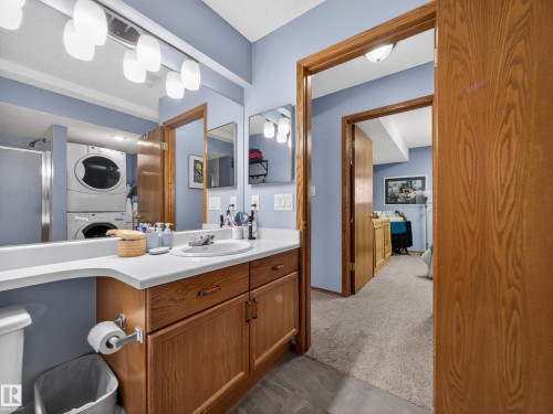 Bathroom featuring a vanity with a white countertop and wood cabinetry - 7 85 Gervais Road, St. Albert, AB - Indoor Photo Showing Bathroom