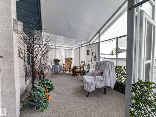 This property features a covered patio with a white ceiling and grey carpeted flooring - 7 85 Gervais Road, St. Albert, AB -  Photo Showing Other Room