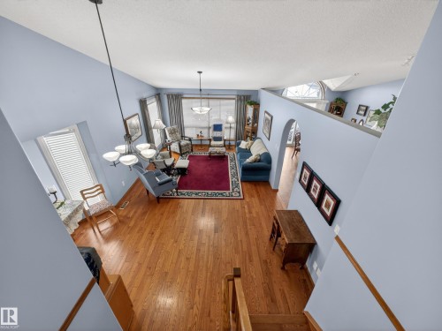 The property features an open-concept living area with hardwood flooring and light blue walls - 7 85 Gervais Road, St. Albert, AB - Indoor Photo Showing Other Room