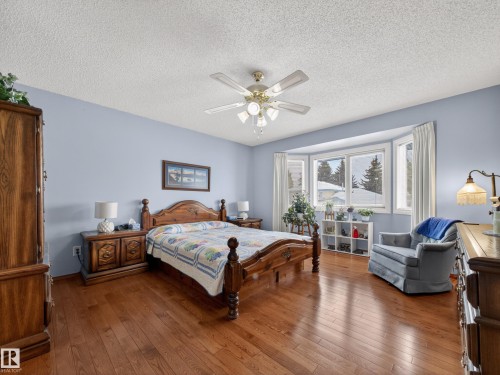 This room features hardwood floors and a bay window - 7 85 Gervais Road, St. Albert, AB - Indoor Photo Showing Bedroom