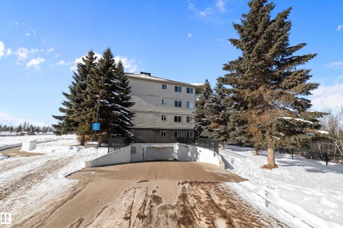 The property features an exterior with a neutral color palette and multiple windows - 114 592 Hooke Road, Edmonton, AB - Outdoor