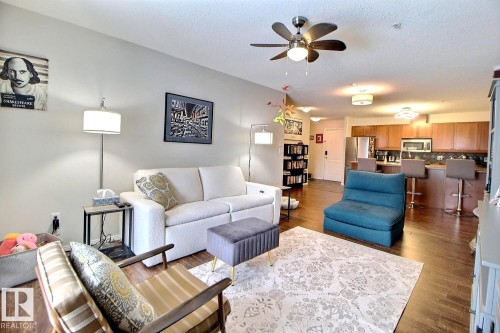 The property features hardwood floors, a ceiling fan, and recessed lighting - 114 592 Hooke Road, Edmonton, AB - Indoor Photo Showing Living Room
