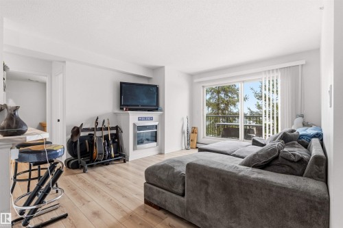 413 17003 67 Avenue, Edmonton, AB - Indoor Photo Showing Living Room With Fireplace