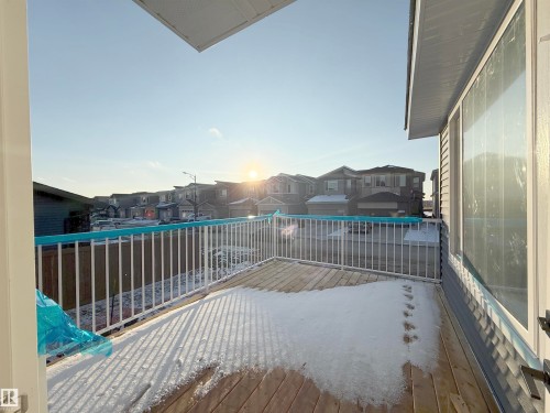 The property features a wooden deck with white railings and an exterior window - 6449 28 Avenue, Edmonton, AB - Outdoor With Exterior