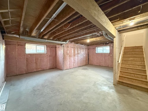 The property features an unfinished basement with exposed wooden ceiling joists, a concrete floor, and insulation on the walls - 6449 28 Avenue, Edmonton, AB - Indoor Photo Showing Basement