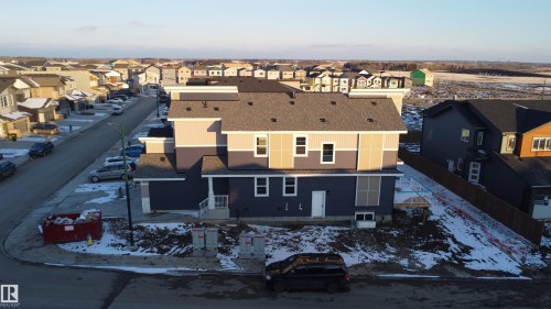 The property features a multi-level design with varying shades of siding and a dark shingled roof - 6449 28 Avenue, Edmonton, AB - Outdoor