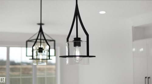Modern pendant lighting fixtures featuring black frames and clear glass shades illuminate the space - 803 30 Avenue, Edmonton, AB - Indoor Photo Showing Other Room