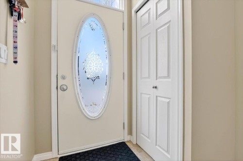 The property features an entryway with a light-colored main door, complete with an oval-shaped decorative glass insert - 1637 Towne Centre Boulevard, Edmonton, AB - Indoor Photo Showing Other Room