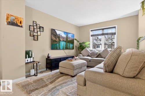 Inviting living area featuring light-toned walls, a window with blinds, and carpeting - 1637 Towne Centre Boulevard, Edmonton, AB - Indoor Photo Showing Living Room