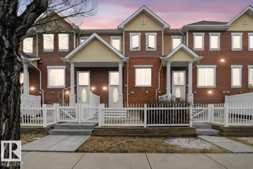 The property features a charming exterior with a blend of brick and siding, multiple windows, and individual covered entryways - 1637 Towne Centre Boulevard, Edmonton, AB - Outdoor With Facade
