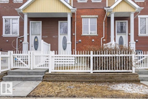 The property features a charming white picket fence and a covered front porch with white columns - 1637 Towne Centre Boulevard, Edmonton, AB - Outdoor With Deck Patio Veranda With Facade