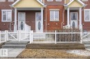 The property features a charming white picket fence and a covered front porch with white columns - 1637 Towne Centre Boulevard, Edmonton, AB  - Outdoor With Deck Patio Veranda With Facade 