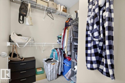 The property includes a walk-in closet with white wire shelving, a hanging rod, and a carpeted floor - 1637 Towne Centre Boulevard, Edmonton, AB - Indoor With Storage