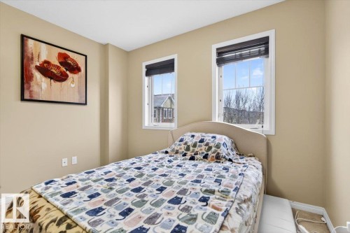 This room features two windows with views of the outdoors, providing natural light - 1637 Towne Centre Boulevard, Edmonton, AB - Indoor Photo Showing Bedroom