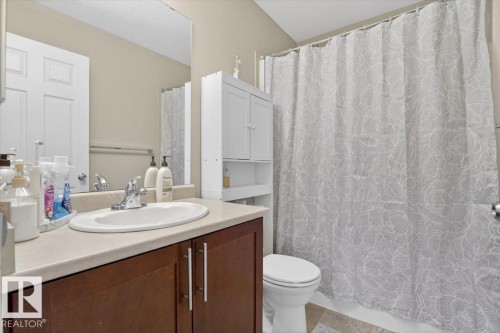 Bathroom with a dark wood vanity, white sink, and light-colored countertop - 1637 Towne Centre Boulevard, Edmonton, AB - Indoor Photo Showing Bathroom
