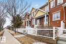 The property features a brick exterior with white trim and a white picket fence - 1637 Towne Centre Boulevard, Edmonton, AB  - Outdoor With Facade 